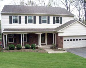 A house with a lawn and a driveway.
