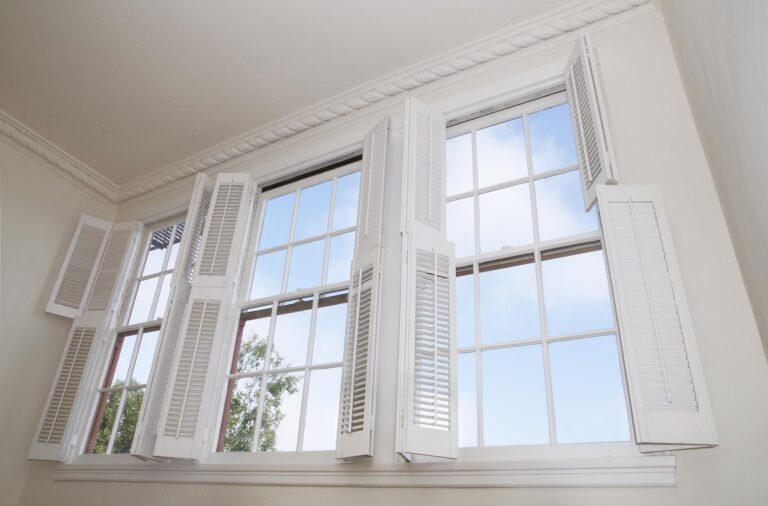 Sky seen through windows with louver shutters